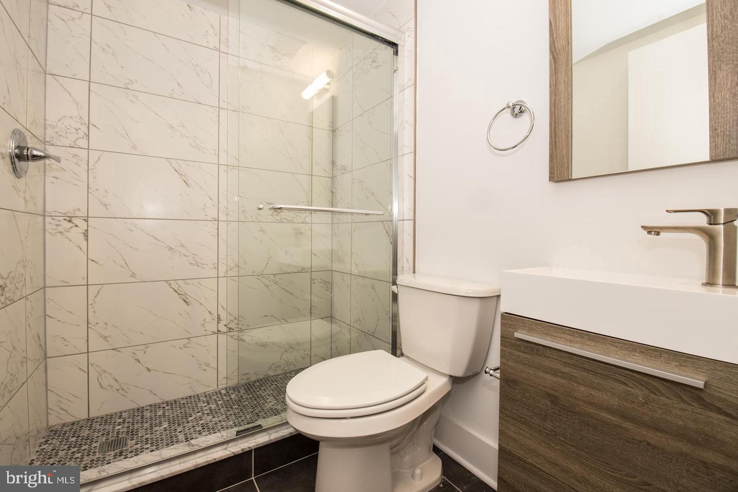 1956 North 8th Street, Unit 2 Philadelphia, PA 19122 - Photo 13 of 23 a bathroom with a sink a toilet and a mirror