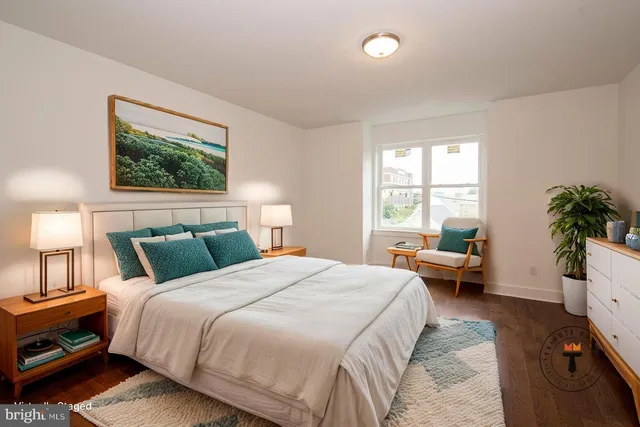 a bedroom with a bed a dresser and a window