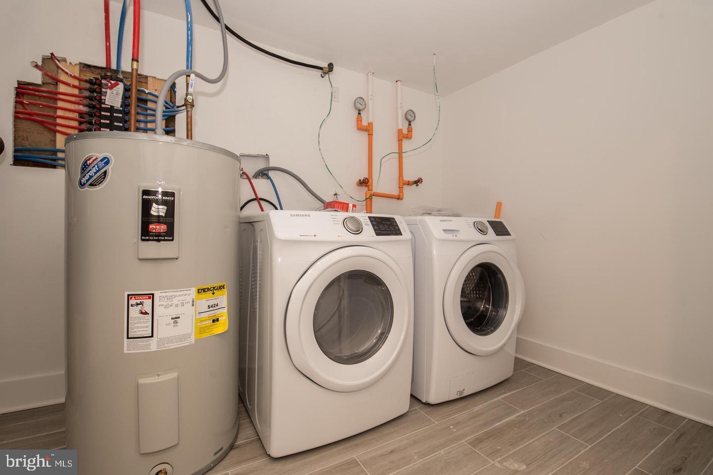 1956 North 8th Street, Unit 2 Philadelphia, PA 19122 - Photo 21 of 23 a utility room with dryer and washer