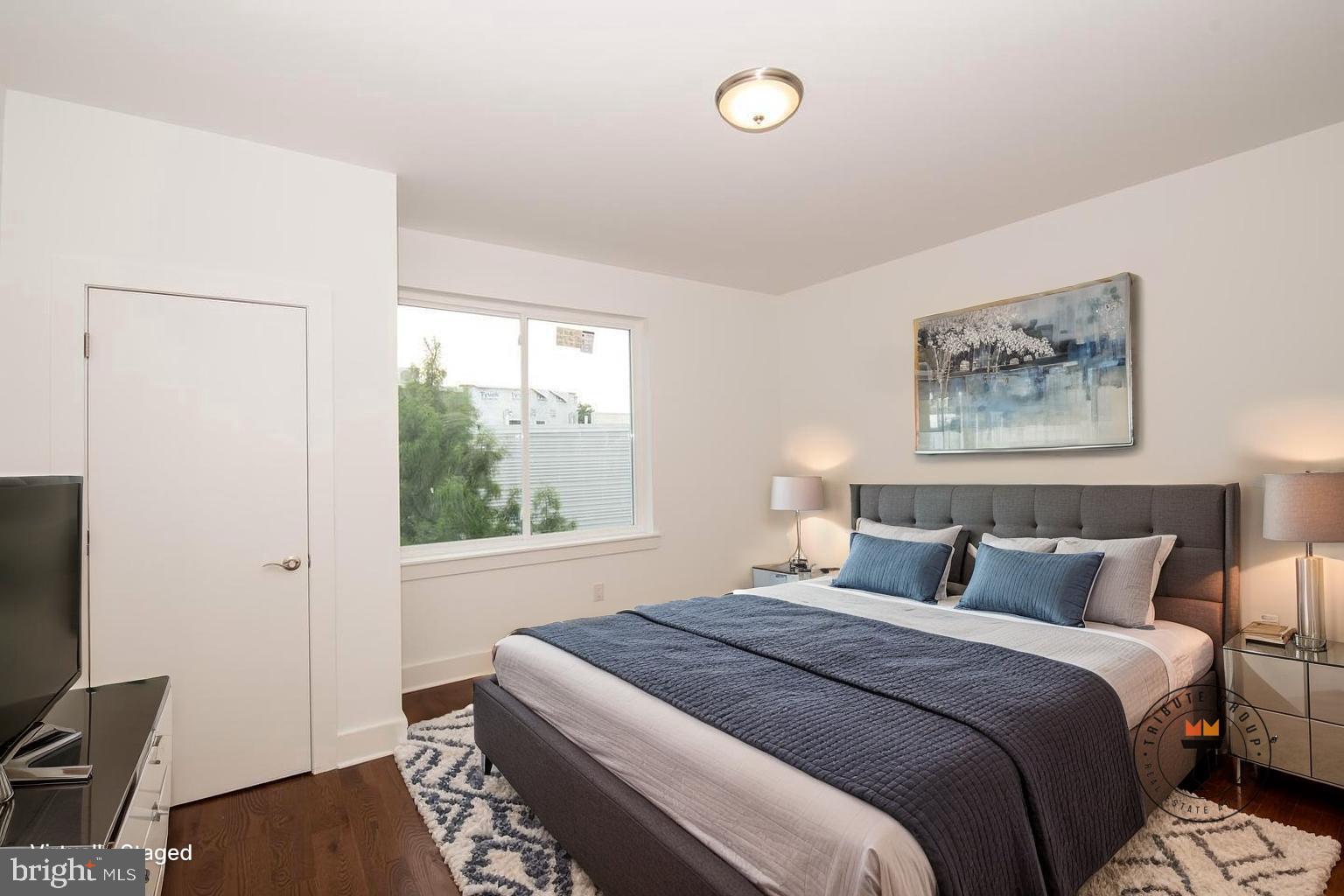 1956 North 8th Street, Unit 2 Philadelphia, PA 19122 - Photo 9 of 23 a bedroom with a bed and a window