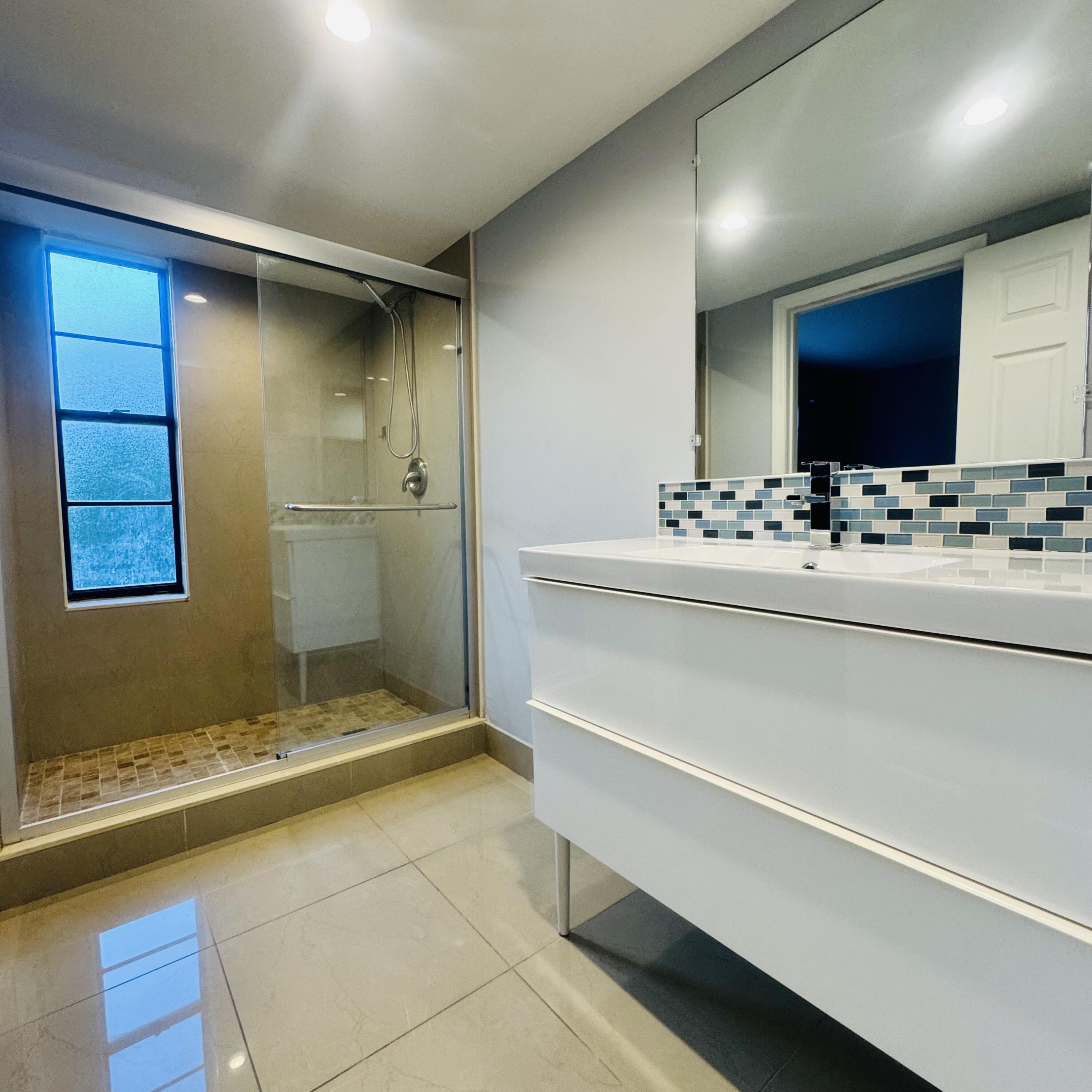 9235 Southwest 8th Street, Unit 503 Boca Raton, FL 33428 - Photo 9 of 17 a bathroom with a sink and a mirror