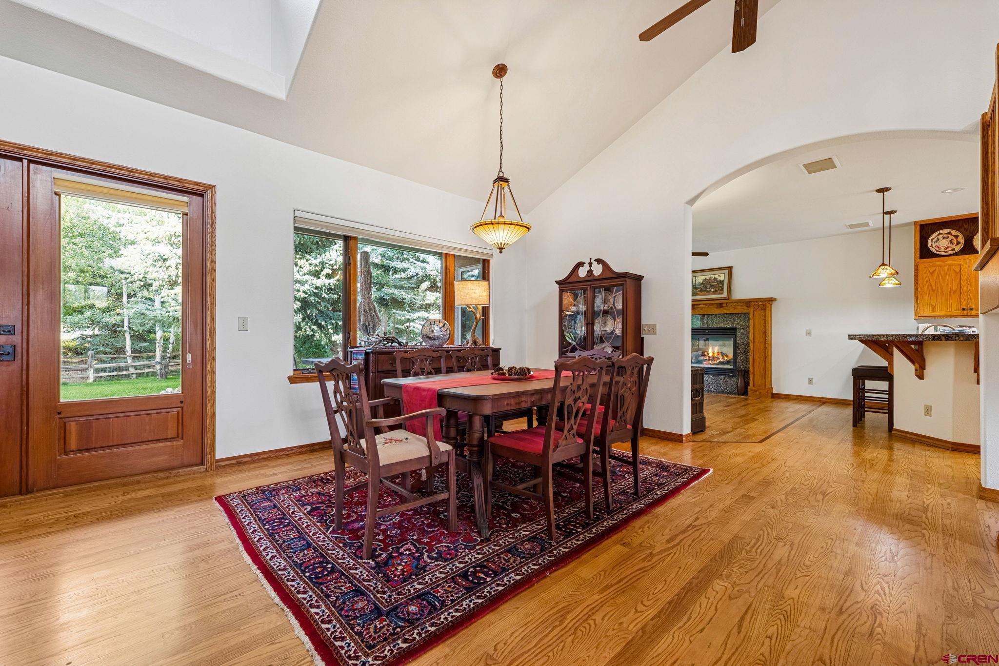 345 Red Rock Road Durango, CO 81301 - Photo 12 of 44 a view of a dining room with furniture window and wooden floor