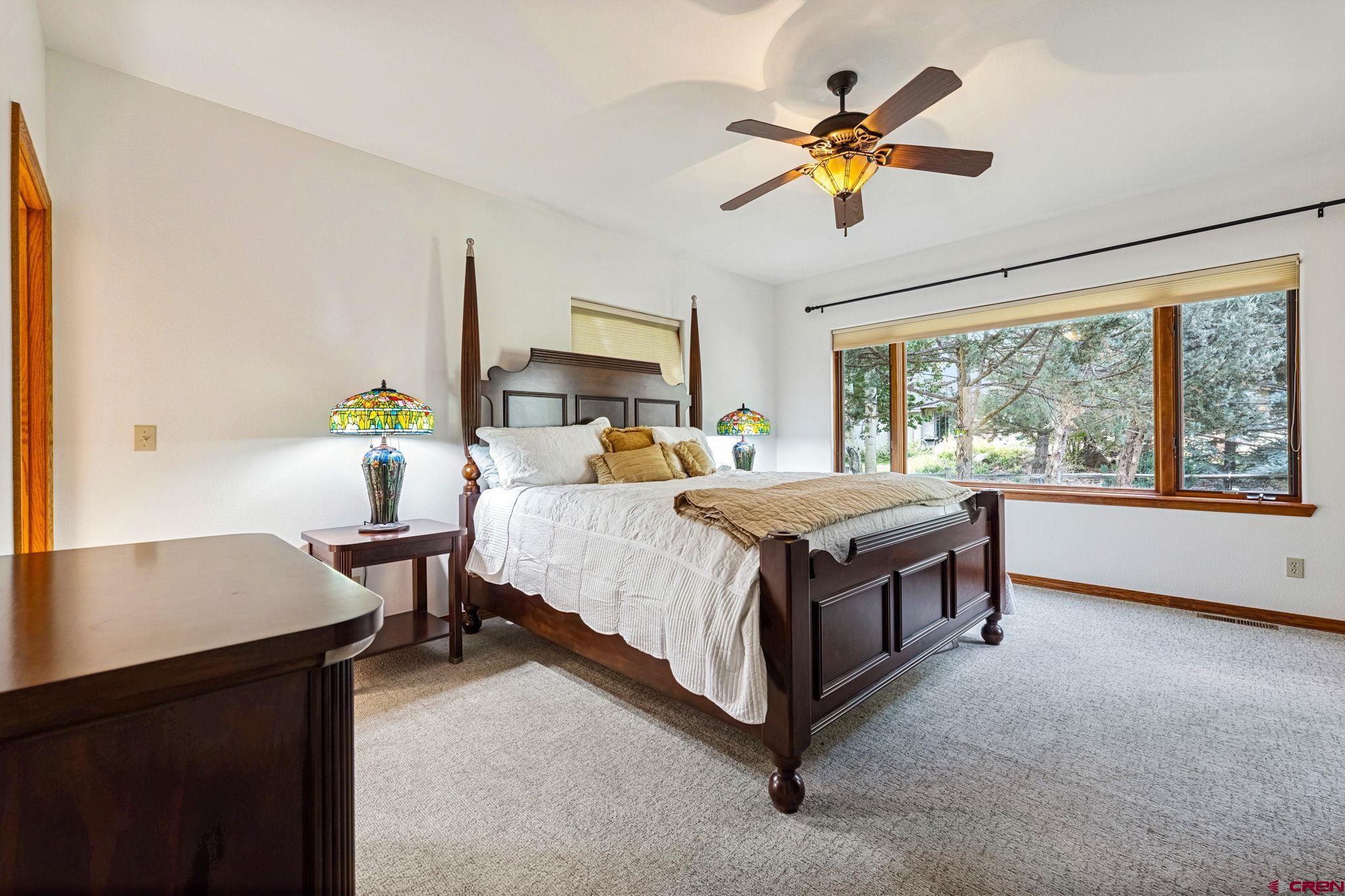 345 Red Rock Road Durango, CO 81301 - Photo 19 of 44 a bed room with a bed and a chandelier