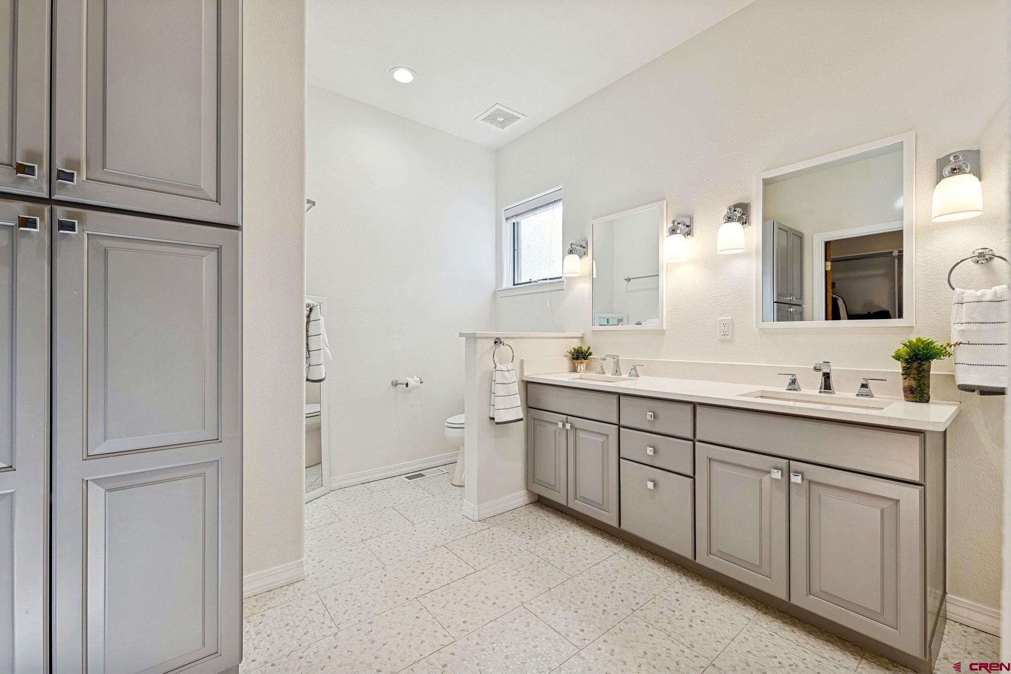 345 Red Rock Road Durango, CO 81301 - Photo 21 of 44 a spacious bathroom with a double vanity sink a mirror and a