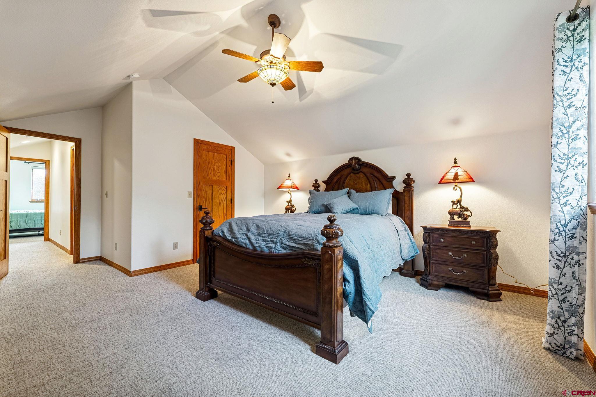 345 Red Rock Road Durango, CO 81301 - Photo 23 of 44 a bed room with a bed and a chandelier