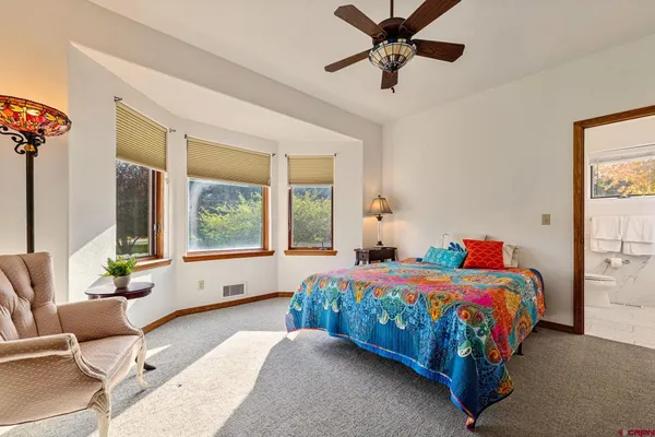 a bedroom with a bed and a couch