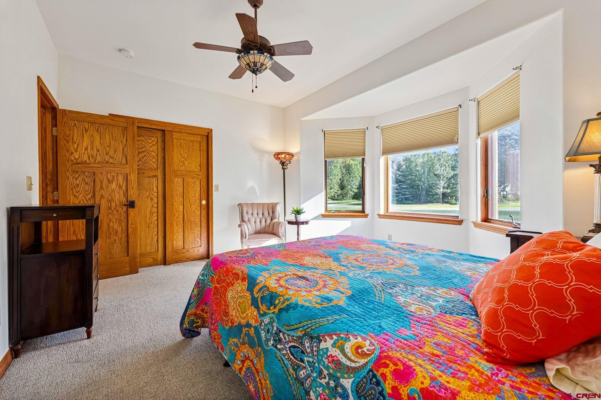 345 Red Rock Road Durango, CO 81301 - Photo 26 of 44 a bedroom with a bed and a chandelier