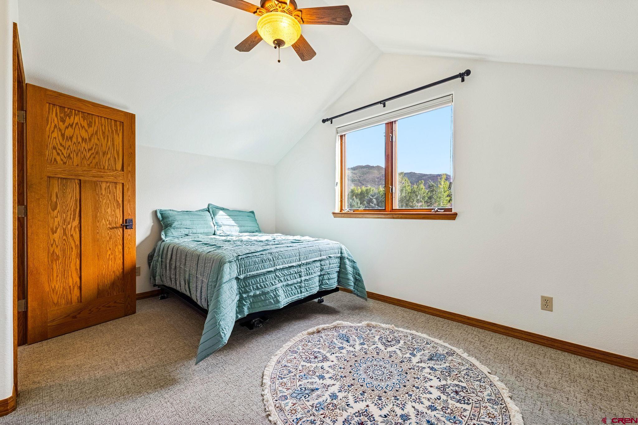 345 Red Rock Road Durango, CO 81301 - Photo 27 of 44 a bedroom with a bed and a window