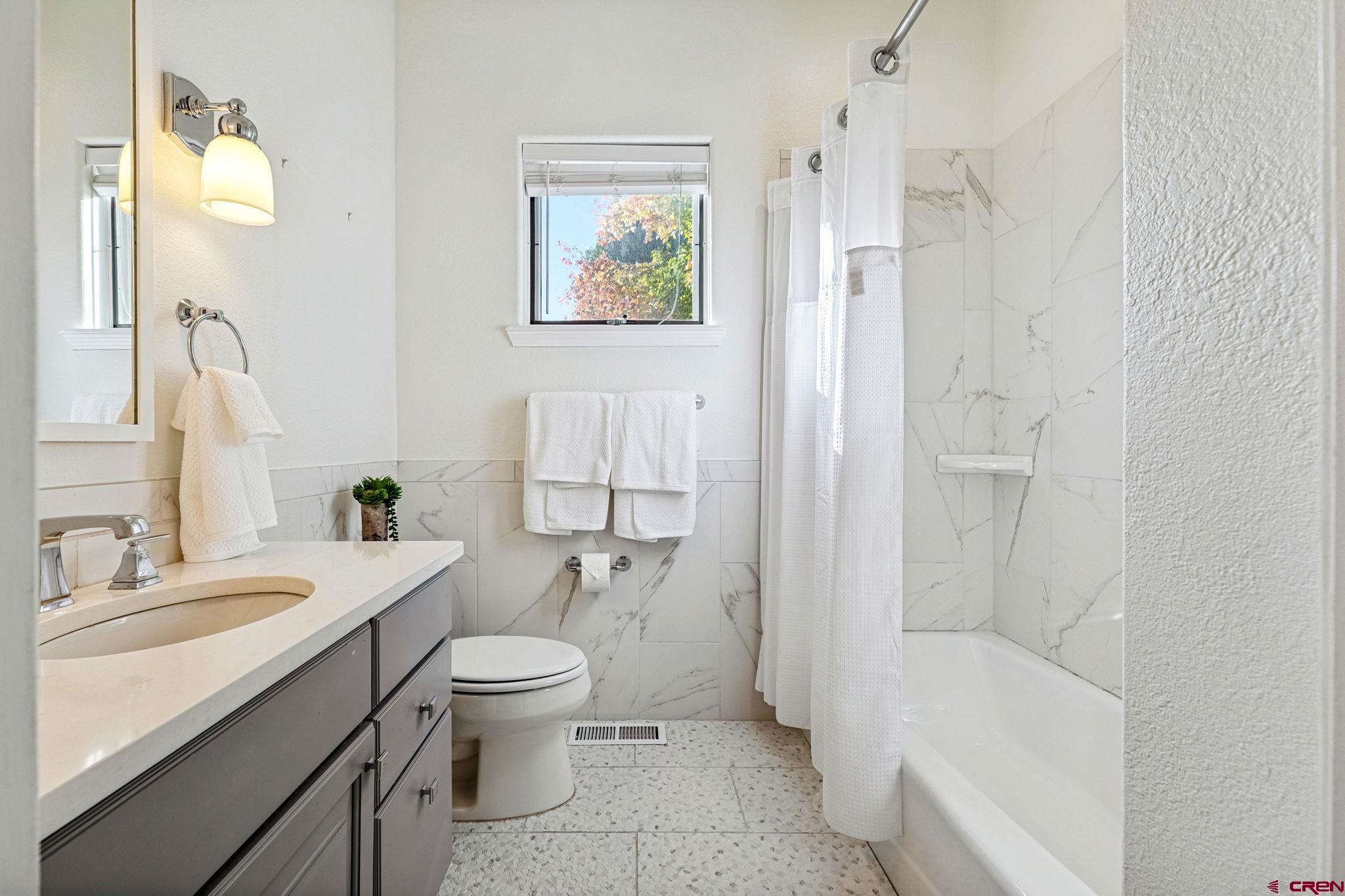 345 Red Rock Road Durango, CO 81301 - Photo 28 of 44 a bathroom with a sink a toilet and shower