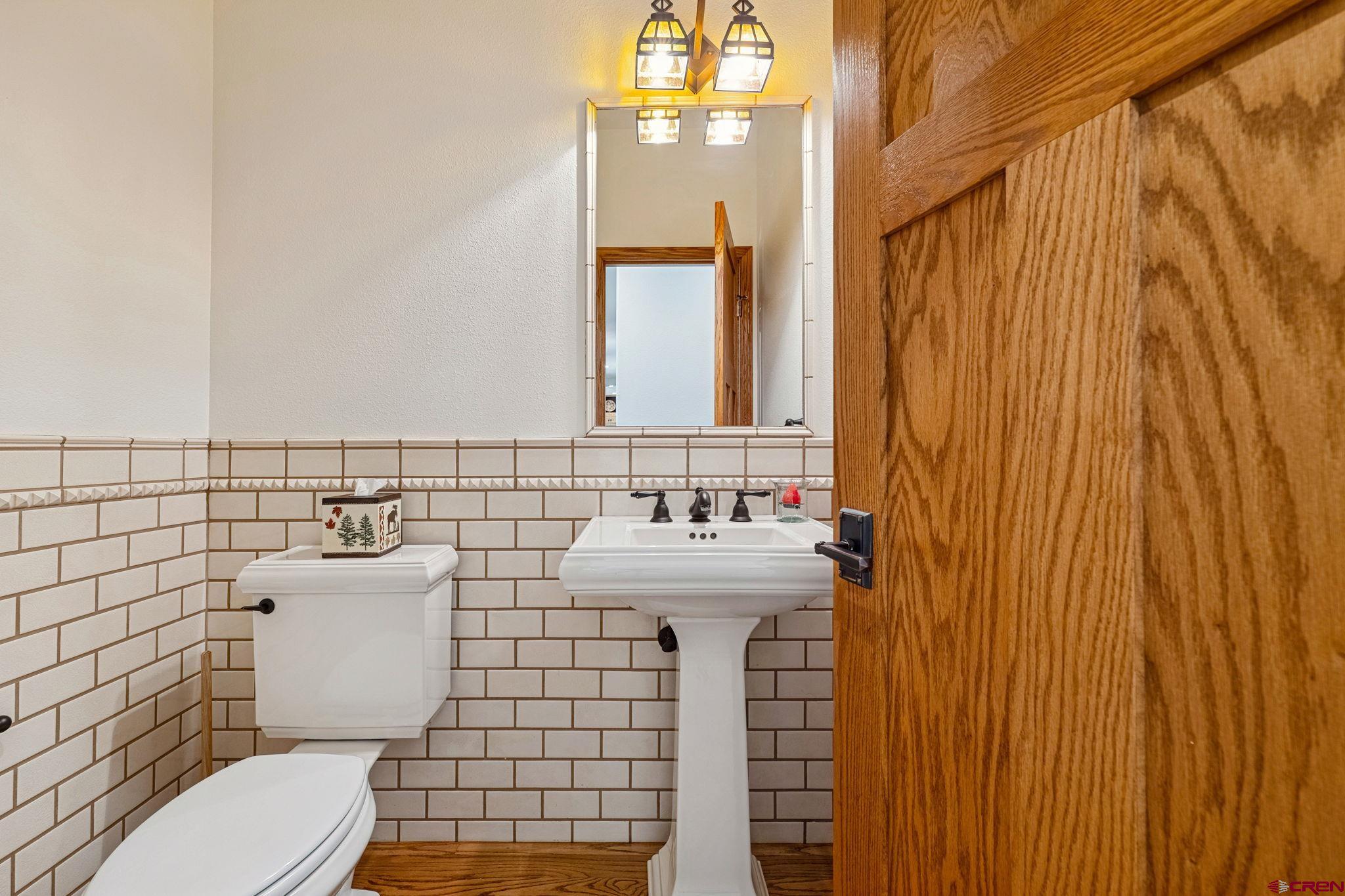 345 Red Rock Road Durango, CO 81301 - Photo 30 of 44 a bathroom with a sink a toilet and mirror