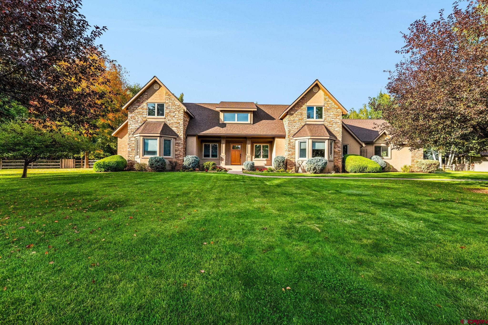 345 Red Rock Road Durango, CO 81301 - Photo 3 of 44 a front view of a house with garden