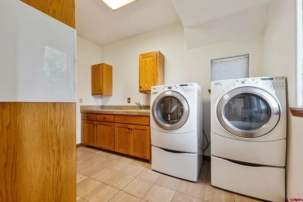 a utility room with sink dryer and washer