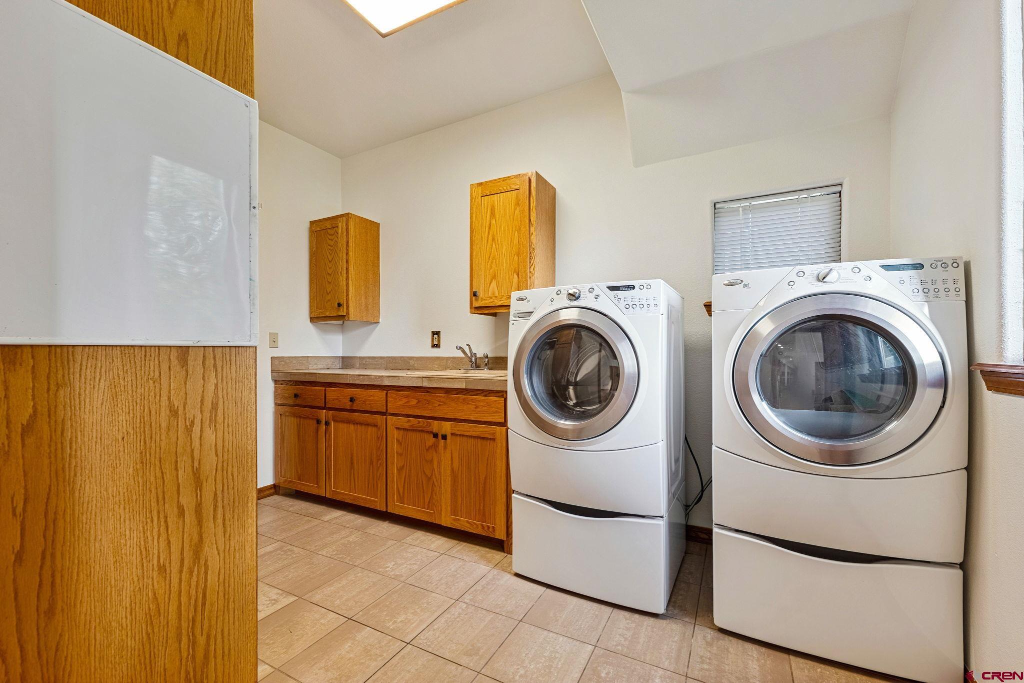 345 Red Rock Road Durango, CO 81301 - Photo 34 of 44 a utility room with sink dryer and washer