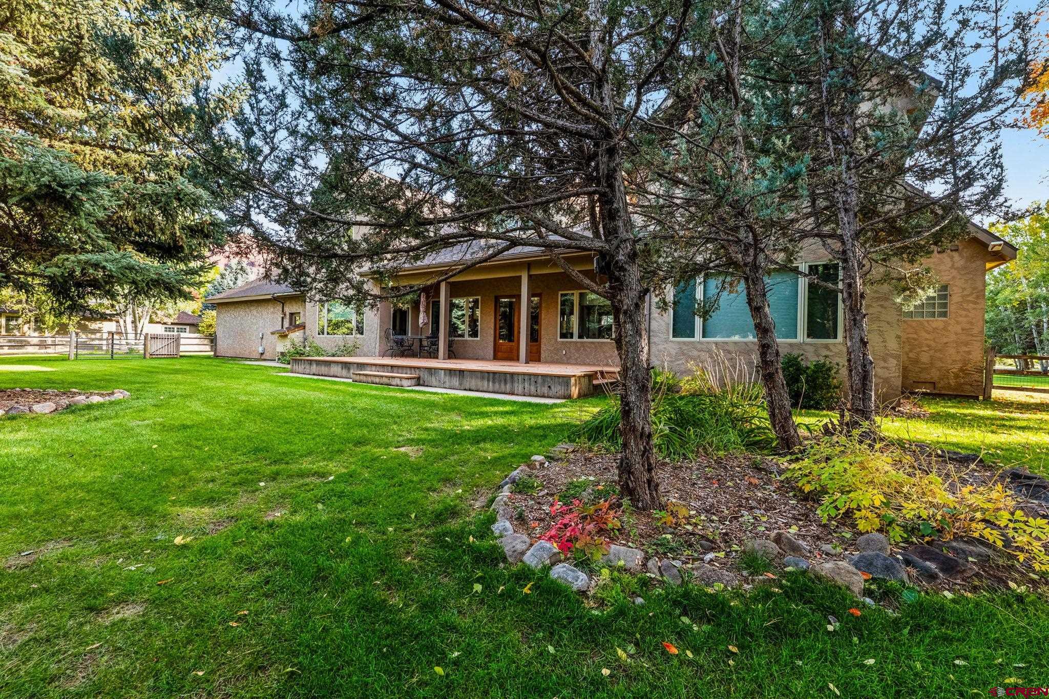 345 Red Rock Road Durango, CO 81301 - Photo 4 of 44 a front view of a house with garden