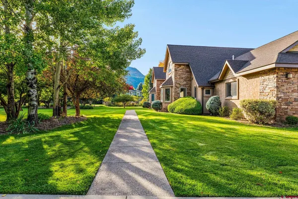 a front view of house with yard and green space