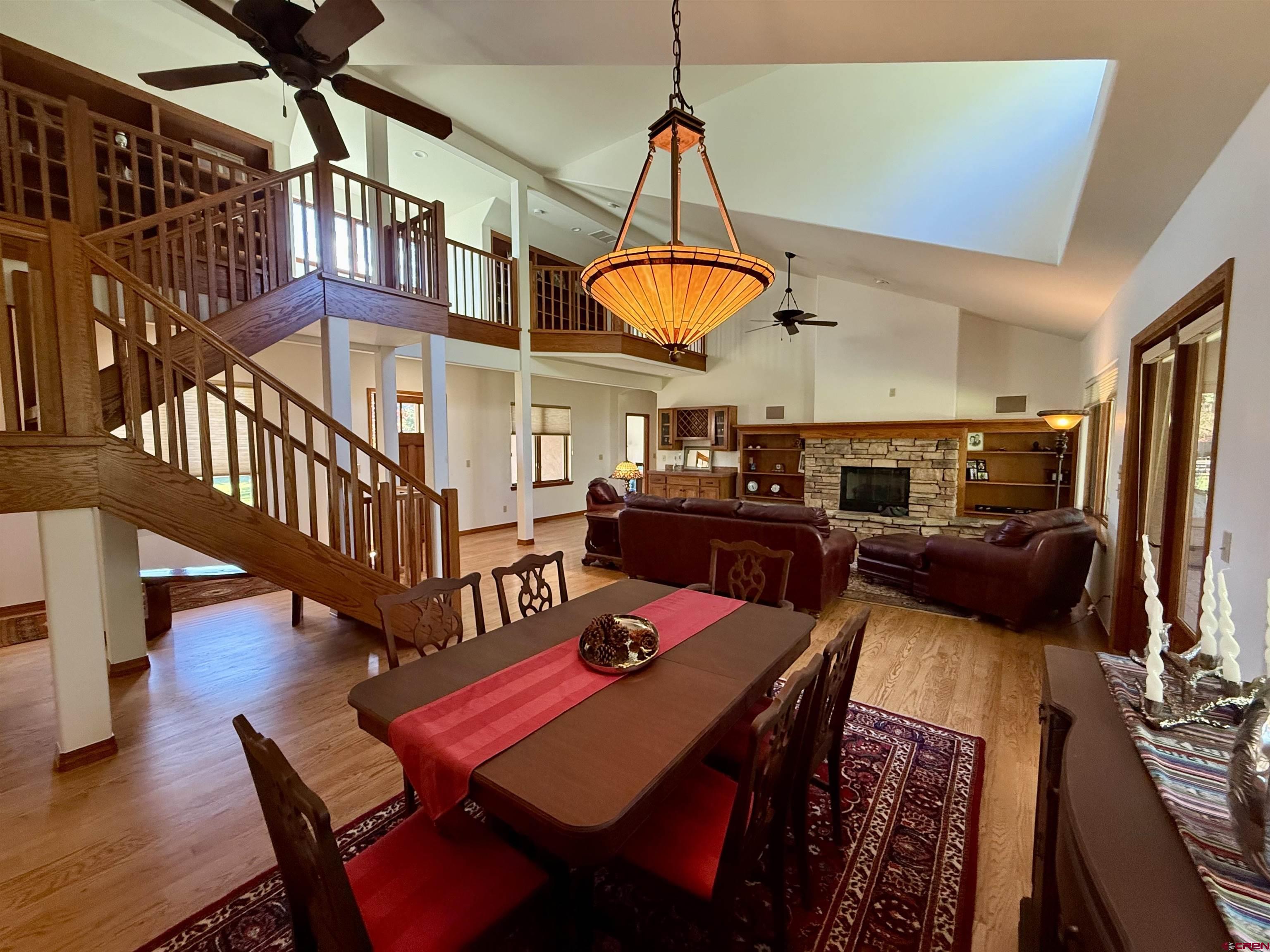 345 Red Rock Road Durango, CO 81301 - Photo 7 of 44 a view of a dining room with furniture a chandelier and wooden floor