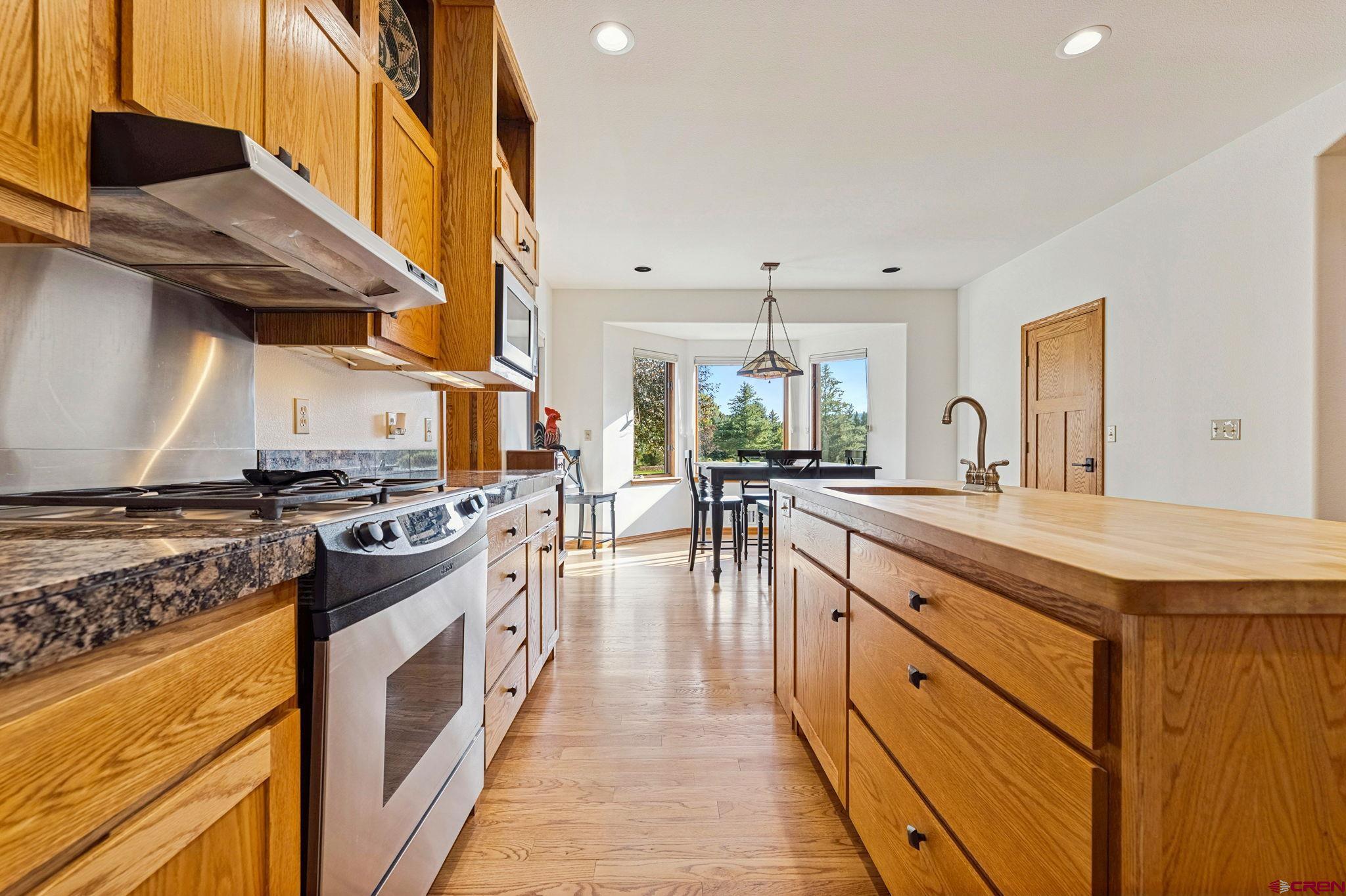 345 Red Rock Road Durango, CO 81301 - Photo 10 of 44 a kitchen with stainless steel appliances granite countertop a stove and a sink