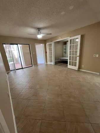 a view of an empty room with a fireplace and a window