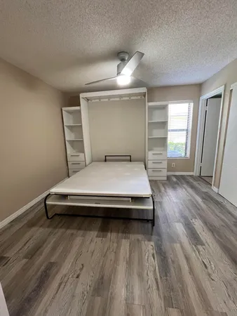 a bedroom with a bed and a mirror