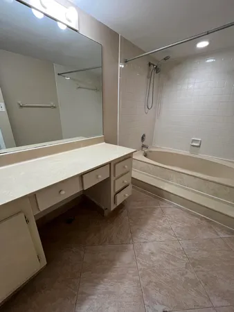 a bathroom with a bathtub and a shower