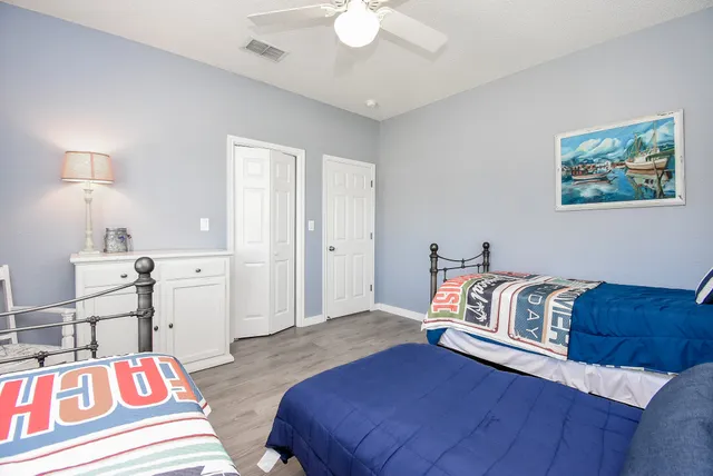 a bathroom with a double vanity sink a toilet and a mirror