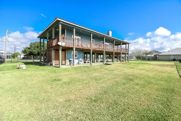 a view of a wooden deck with a yard