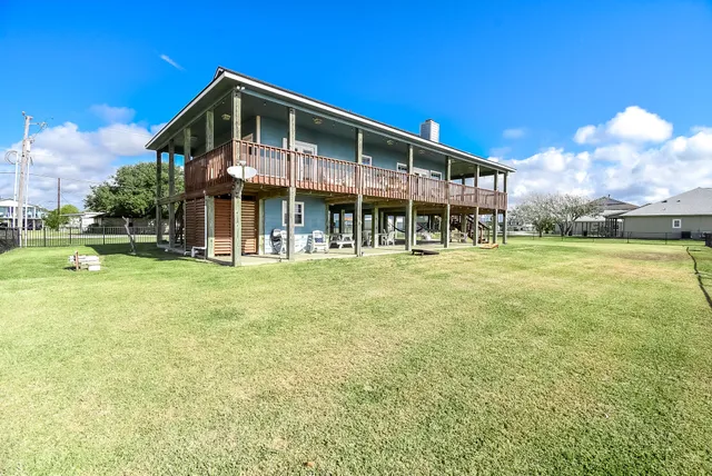 a view of a wooden deck with a yard