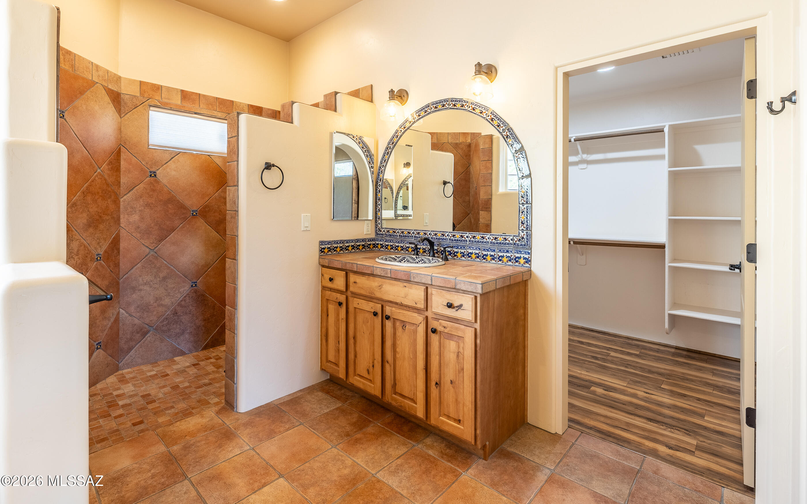 5550 West Open R Place Tucson, AZ 85713 - Photo 28 of 48 Arched mirrors with ornate tile detailing add a touch of timeless charm!