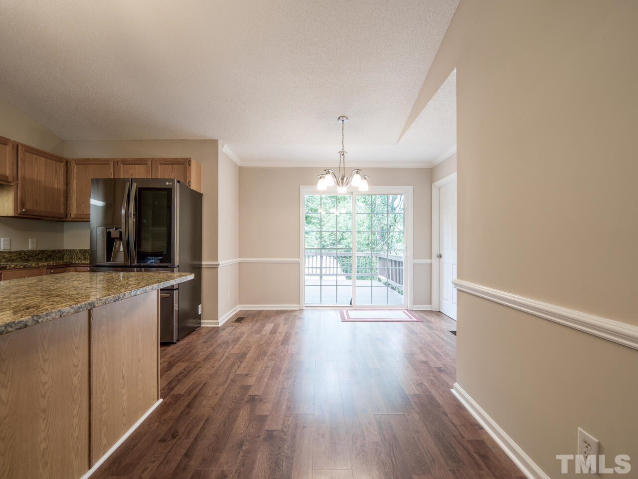745 Brewer Circle Wake Forest, NC 27587 - Photo 12 of 43 a large kitchen with a wooden floor and outdoor space