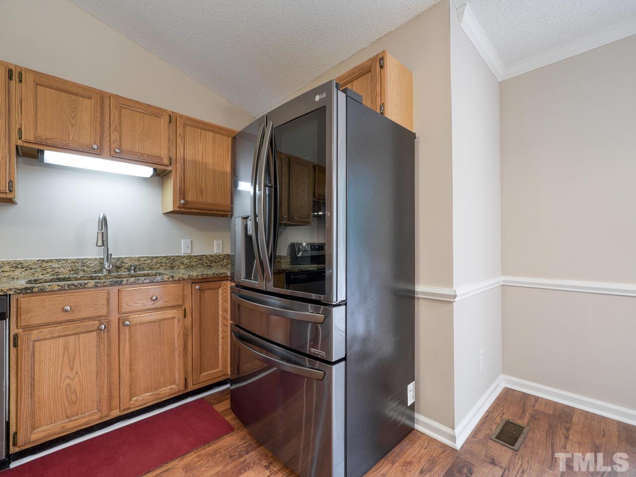 745 Brewer Circle Wake Forest, NC 27587 - Photo 14 of 43 a kitchen with stainless steel appliances granite countertop a refrigerator and a sink