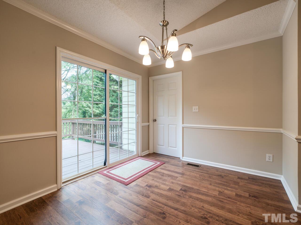 745 Brewer Circle Wake Forest, NC 27587 - Photo 18 of 43 wooden floor in an empty room with a window