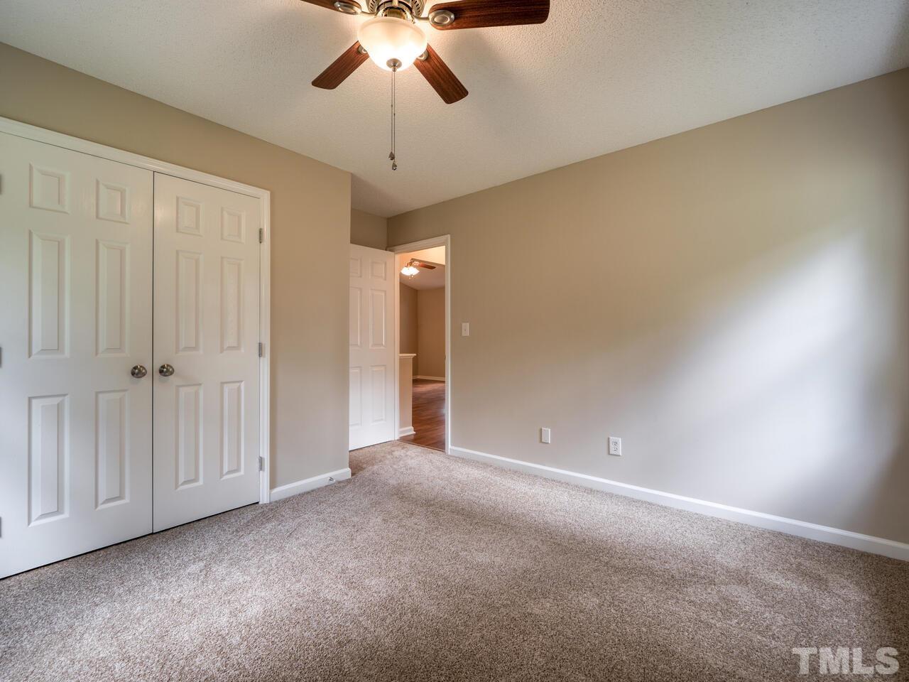 745 Brewer Circle Wake Forest, NC 27587 - Photo 20 of 43 an empty room with a chandelier fan and closet area