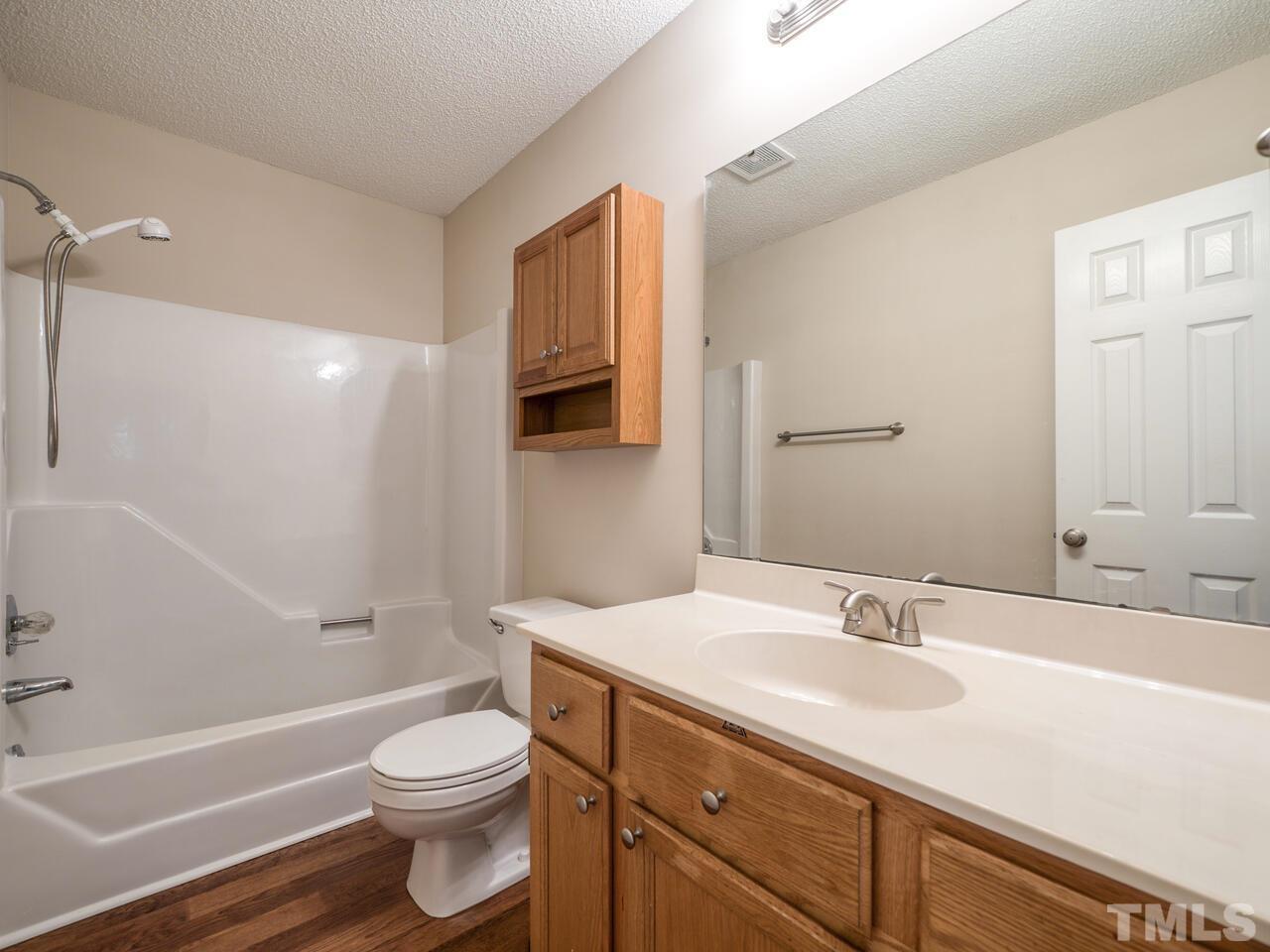 745 Brewer Circle Wake Forest, NC 27587 - Photo 22 of 43 a bathroom with a sink a toilet and shower