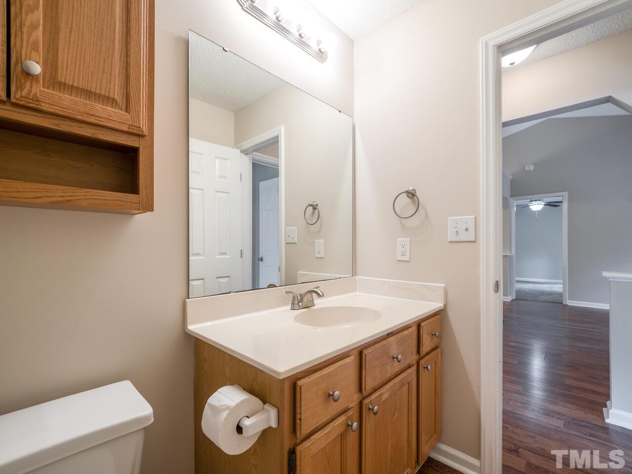745 Brewer Circle Wake Forest, NC 27587 - Photo 23 of 43 a bathroom with a sink a toilet and a mirror