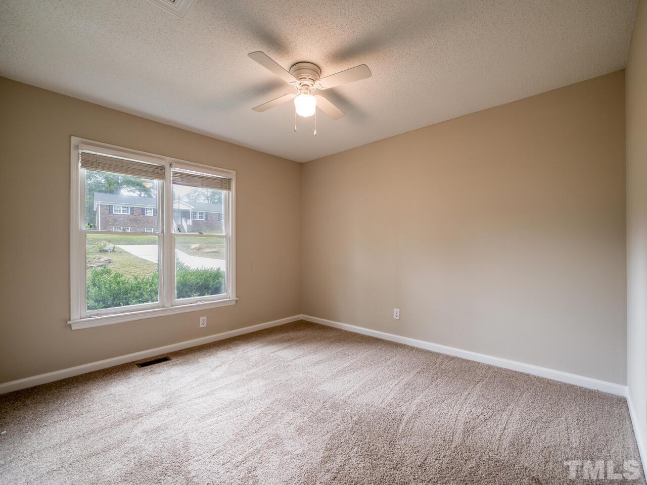 745 Brewer Circle Wake Forest, NC 27587 - Photo 24 of 43 an empty room with a window and a ceiling fan