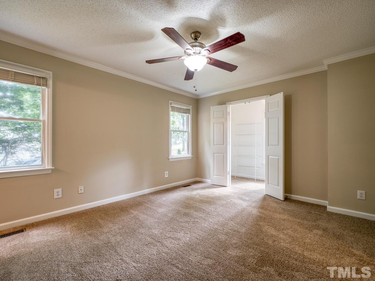 745 Brewer Circle Wake Forest, NC 27587 - Photo 27 of 43 an empty room with ceiling fan and windows