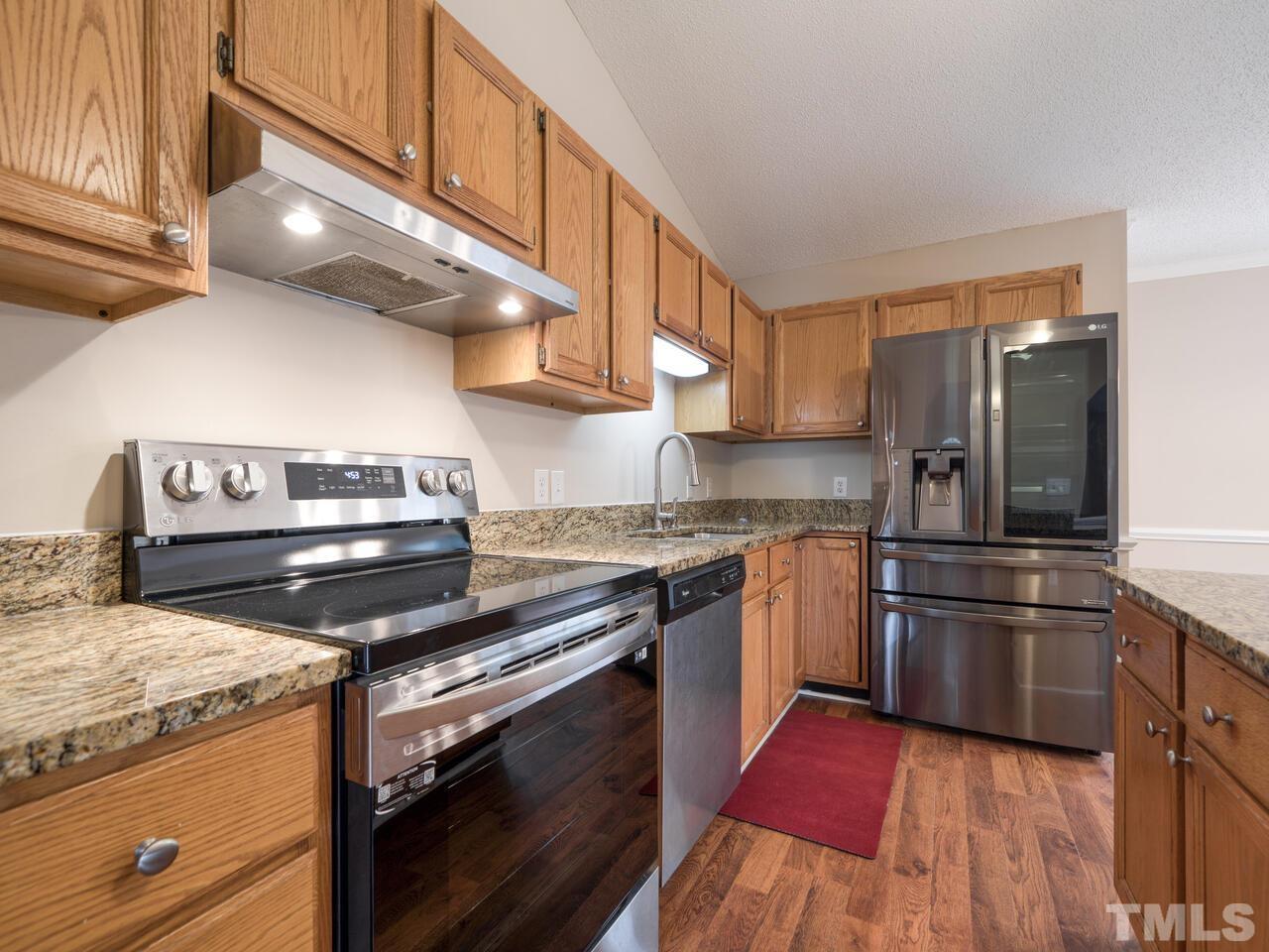 745 Brewer Circle Wake Forest, NC 27587 - Photo 3 of 43 a kitchen with a stove a microwave and a refrigerator