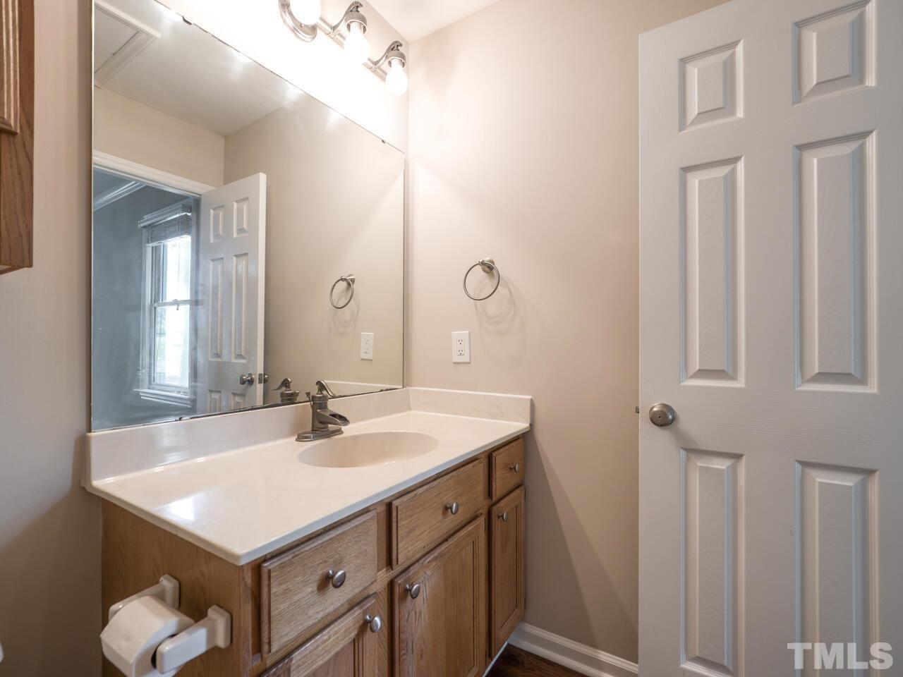 745 Brewer Circle Wake Forest, NC 27587 - Photo 33 of 43 a bathroom with a sink and a mirror