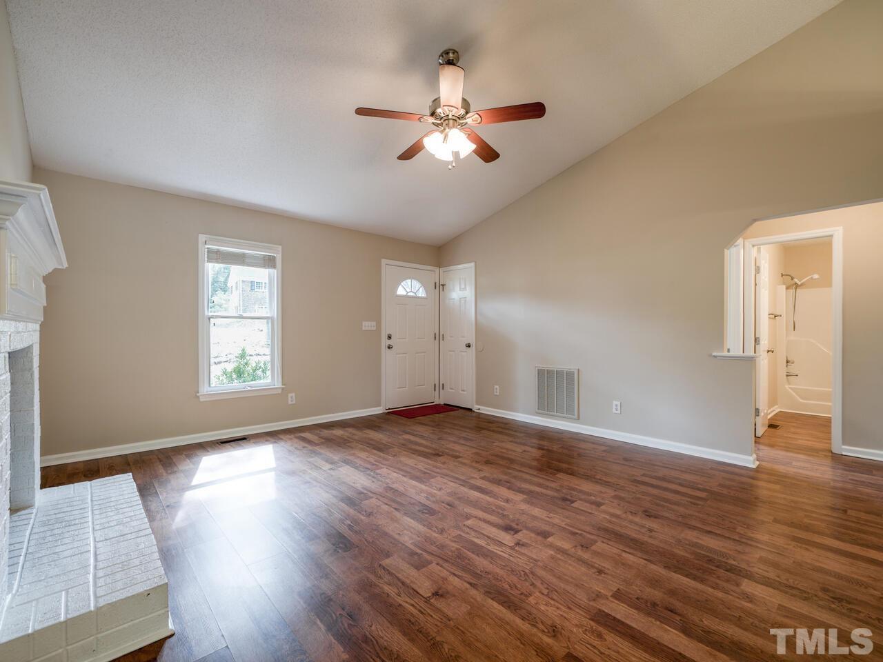 745 Brewer Circle Wake Forest, NC 27587 - Photo 4 of 43 an empty room with wooden floor and windows