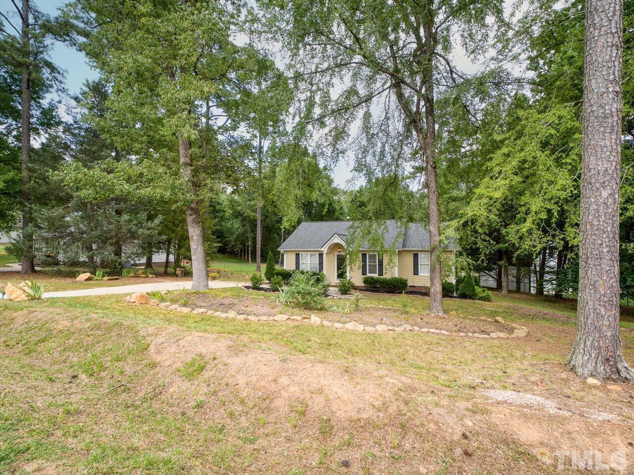 745 Brewer Circle Wake Forest, NC 27587 - Photo 42 of 43 a front view of a house with a yard and trees