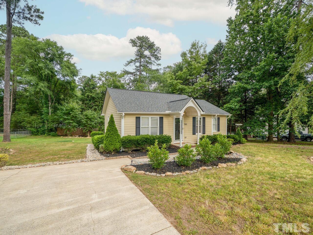 745 Brewer Circle Wake Forest, NC 27587 - Photo 6 of 43 a front view of a house with a yard and trees