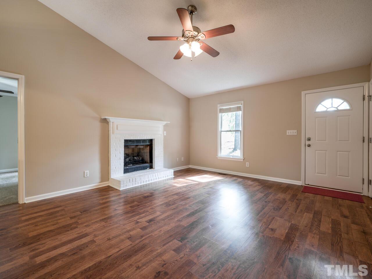 745 Brewer Circle Wake Forest, NC 27587 - Photo 8 of 43 a view of an empty room with wooden floor and a window