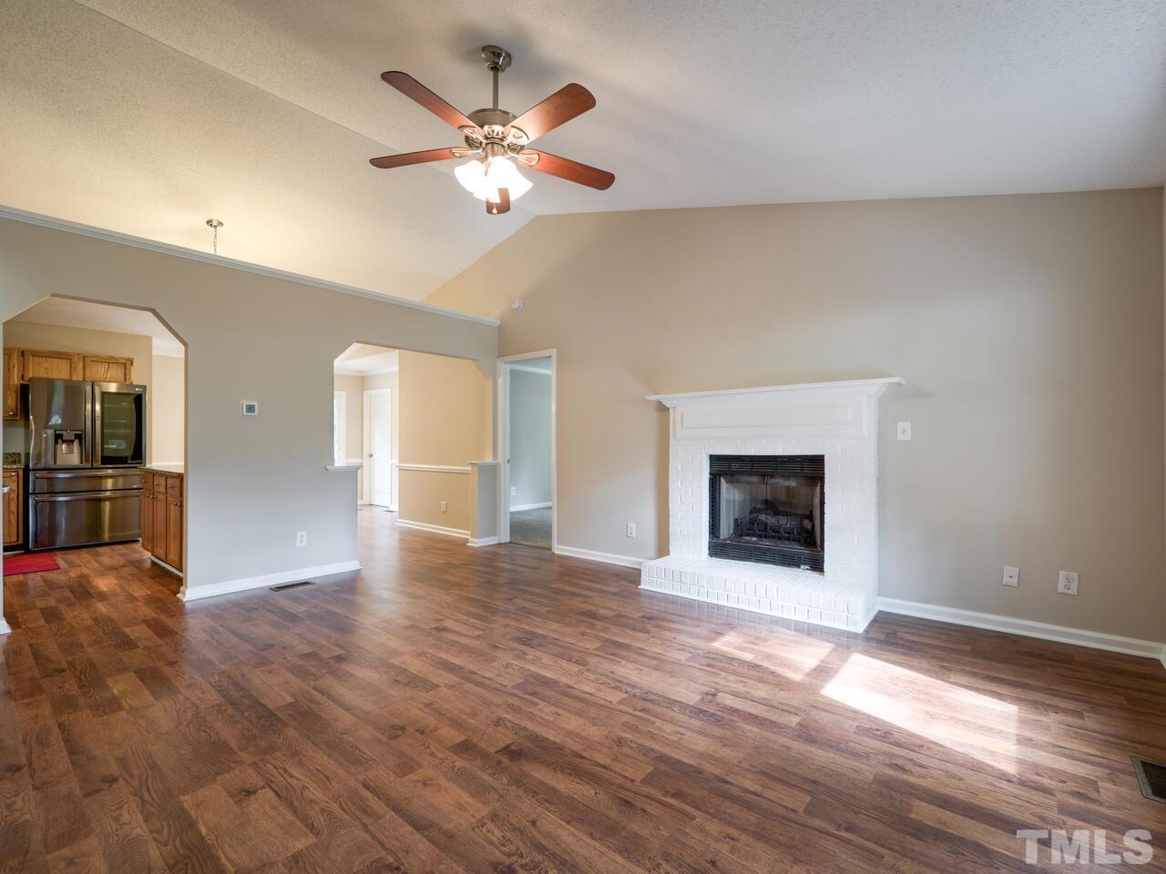 745 Brewer Circle Wake Forest, NC 27587 - Photo 9 of 43 a view of an empty room with window and wooden floor