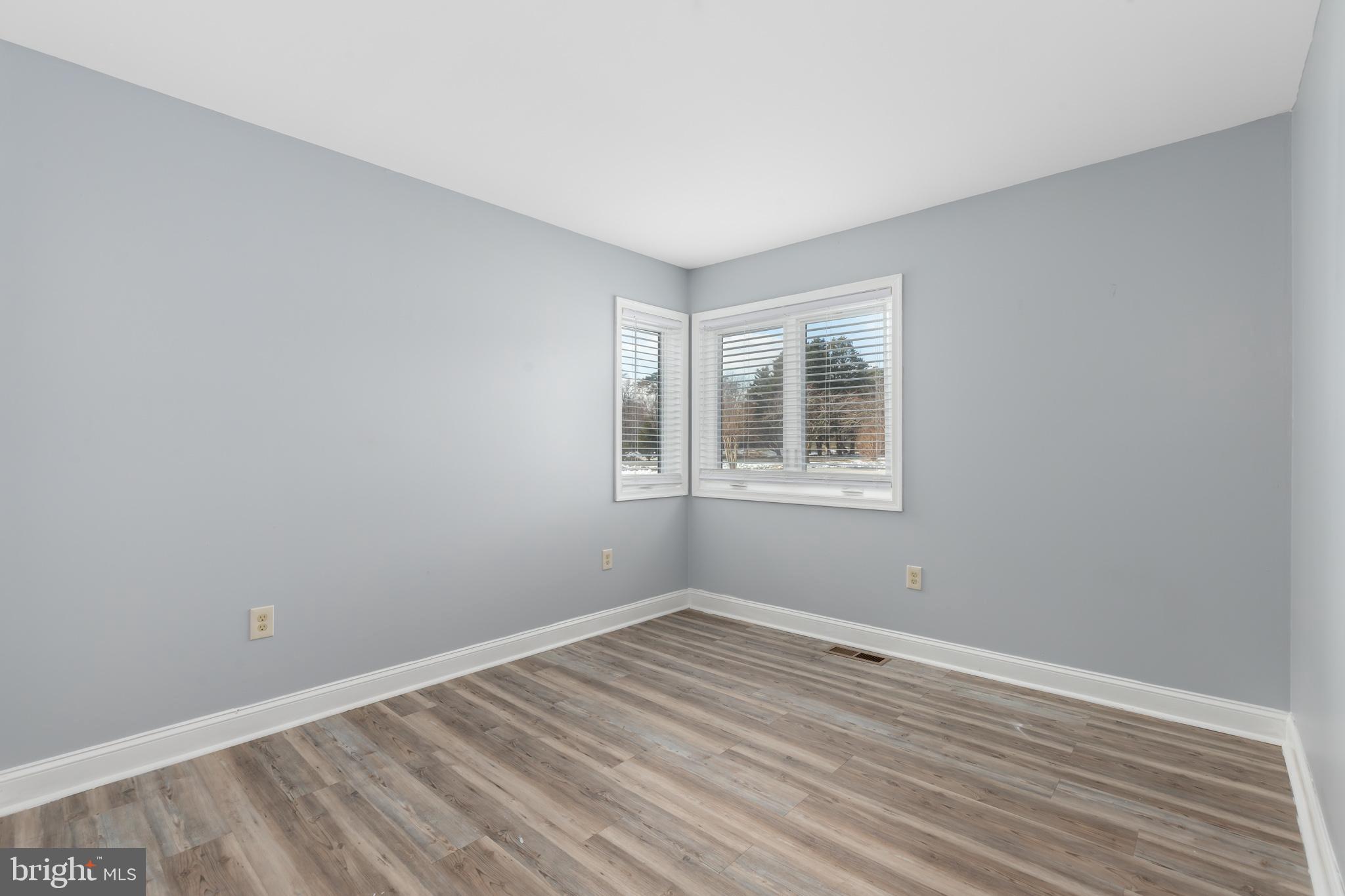 11602 Masters Lane, Unit 120 Berlin, MD 21811 - Photo 13 of 29 wooden floor in an empty room with a window