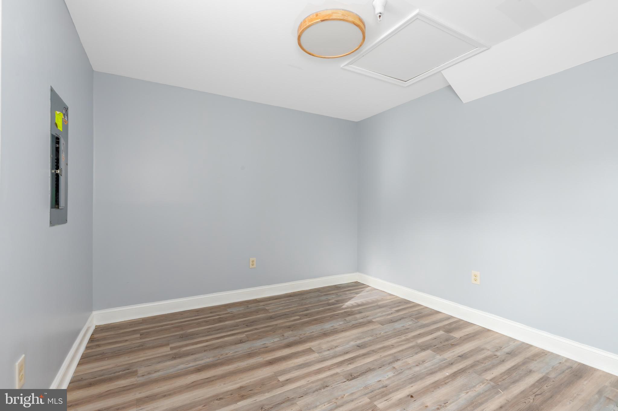 11602 Masters Lane, Unit 120 Berlin, MD 21811 - Photo 17 of 29 a view of a room with wooden floor and fan