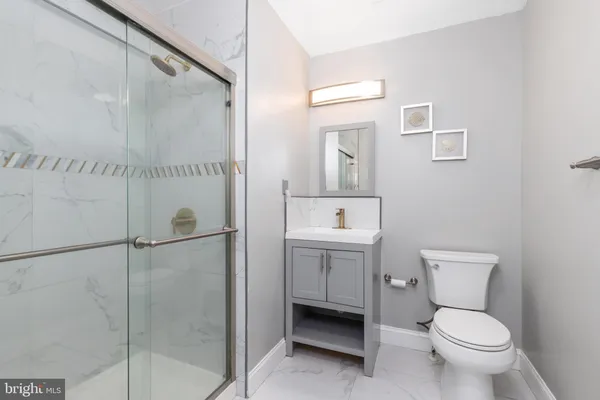 a bathroom with a toilet sink and a shower