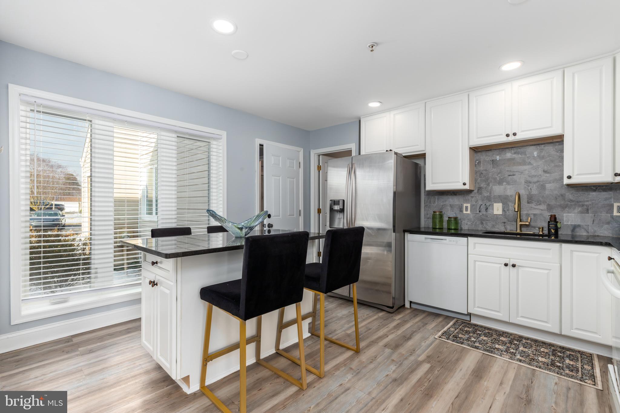 11602 Masters Lane, Unit 120 Berlin, MD 21811 - Photo 2 of 29 a kitchen with granite countertop a sink cabinets and stainless steel appliances