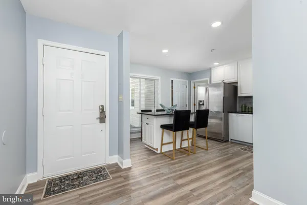 a view of kitchen with stainless steel appliances refrigerator sink and stove