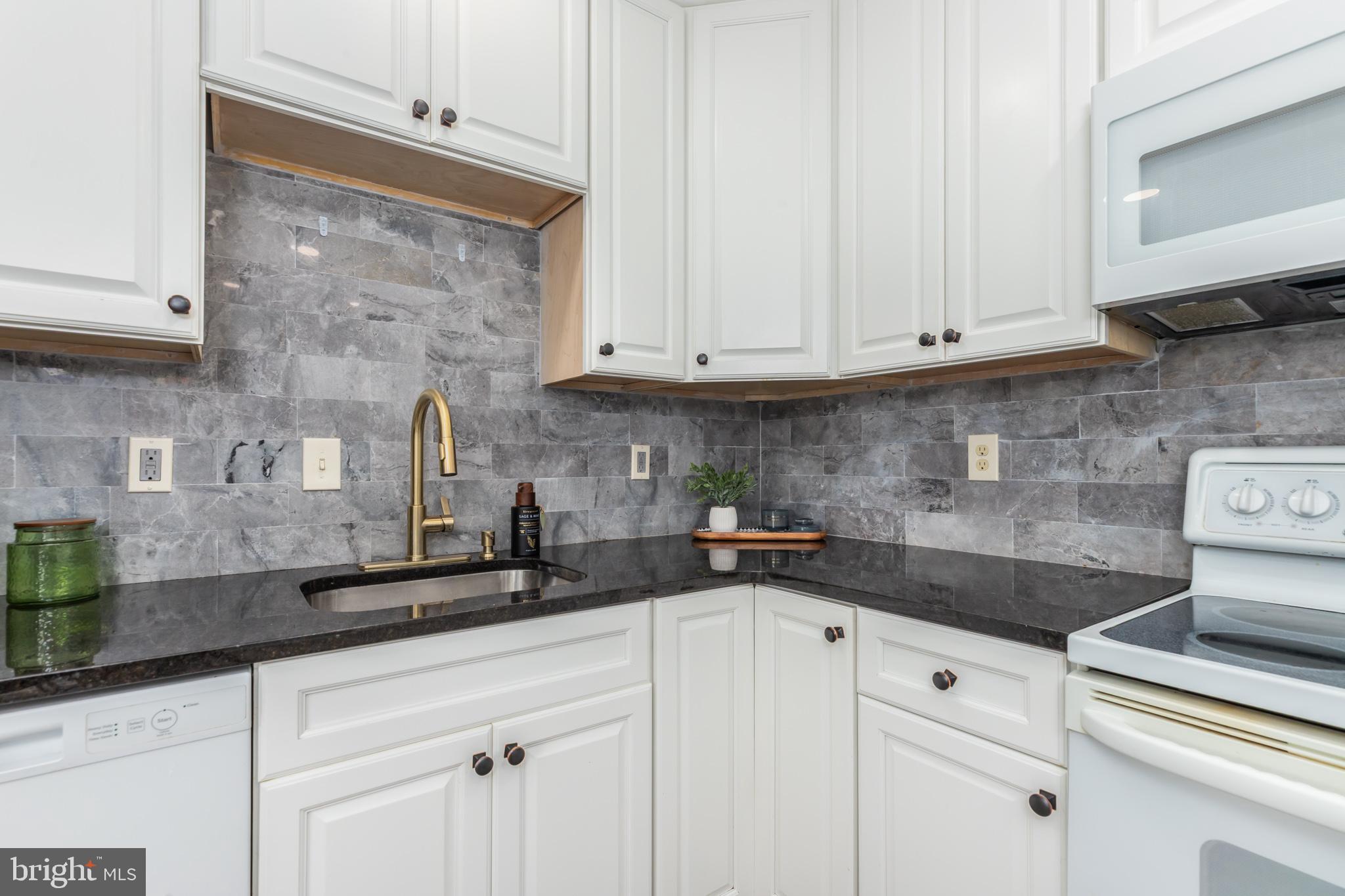 11602 Masters Lane, Unit 120 Berlin, MD 21811 - Photo 4 of 29 a kitchen with stainless steel appliances granite countertop white cabinets sink and granite counter tops