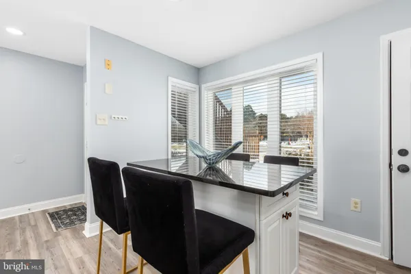 a dining room with furniture and wooden floor